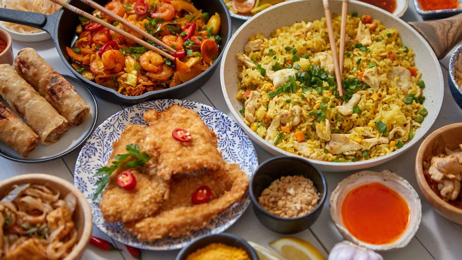 asian-food-served-plates-pans-and-bowls-full-of-2023-11-27-05-15-24-utc